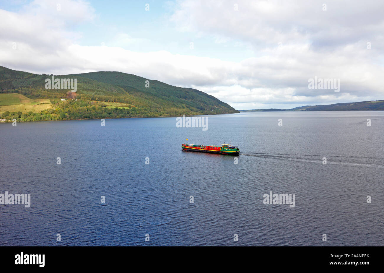 A view of Loch Ness with a commercial vessel making way in the Highlands of Scotland, United Kingdom, Europe. Stock Photo