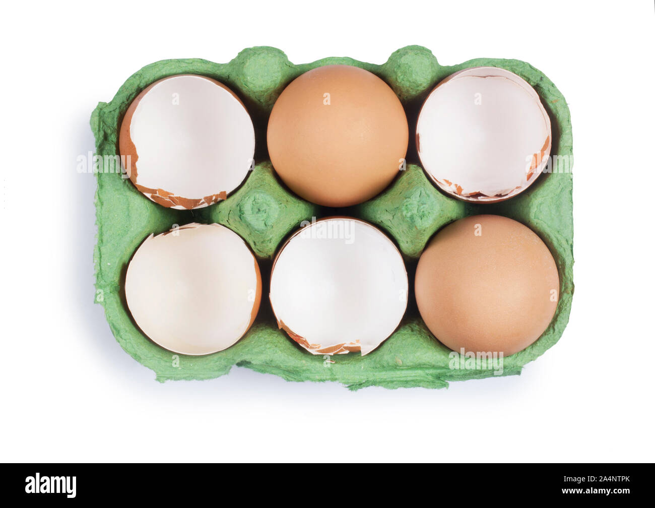 Studio shot of cracked egg shells in an egg box isolated on white - John Gollop Stock Photo