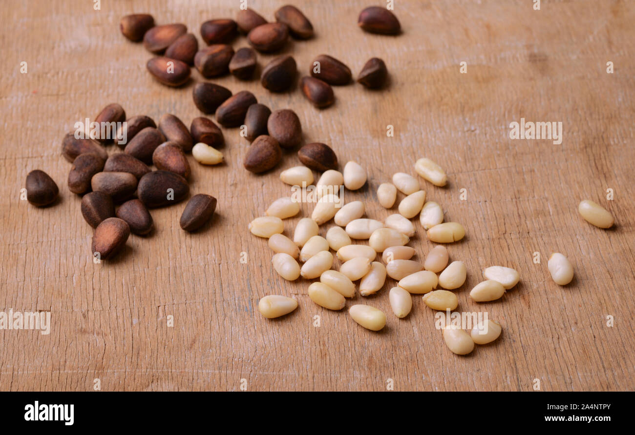 Group of pine nuts on wooden background Stock Photo