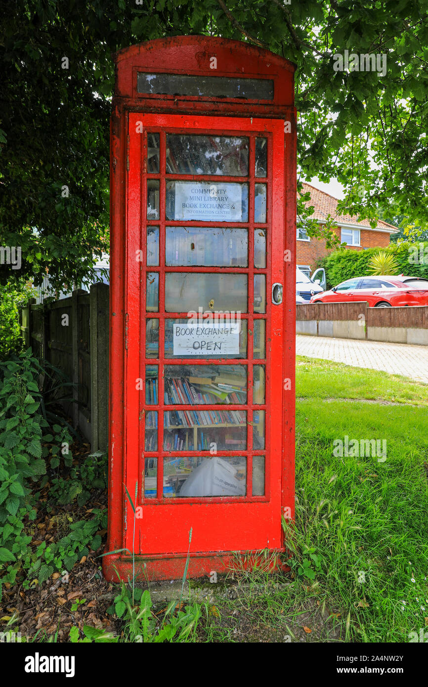 A Community mini library and book exchange in an old telephone box or kiosk at Hardley, Norfolk, England, UK Stock Photo