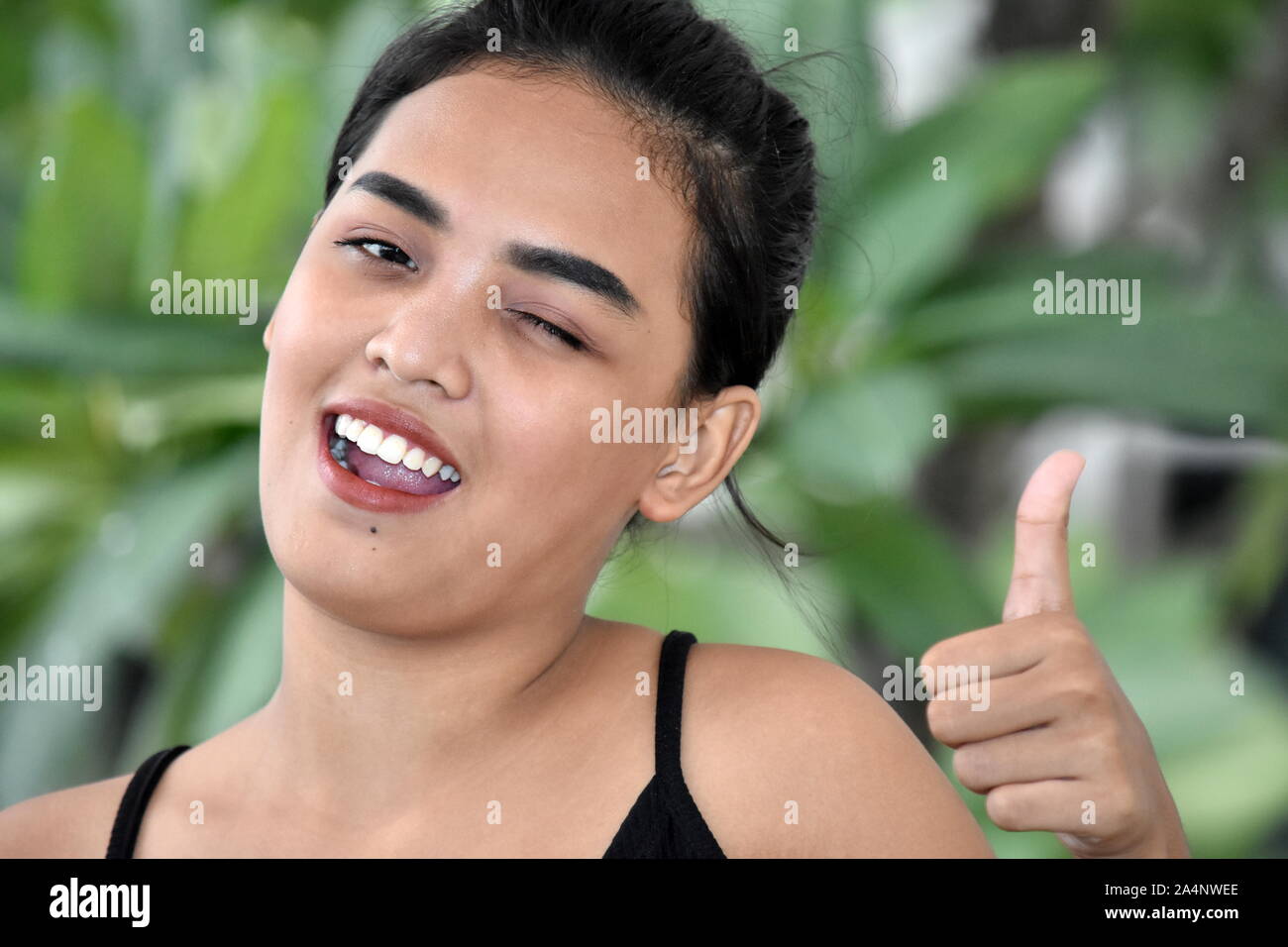Young Asian Girl With Thumbs Up Stock Photo - Alamy