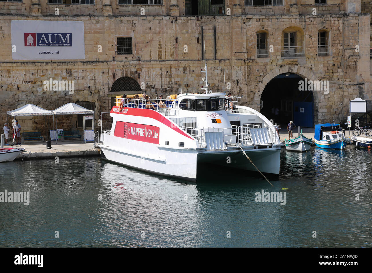 The Valletta Ferry Services boat moored in Vittoriosa Yacht Harbour before making the journey from the Three Cities to Valletta in Malta Stock Photo