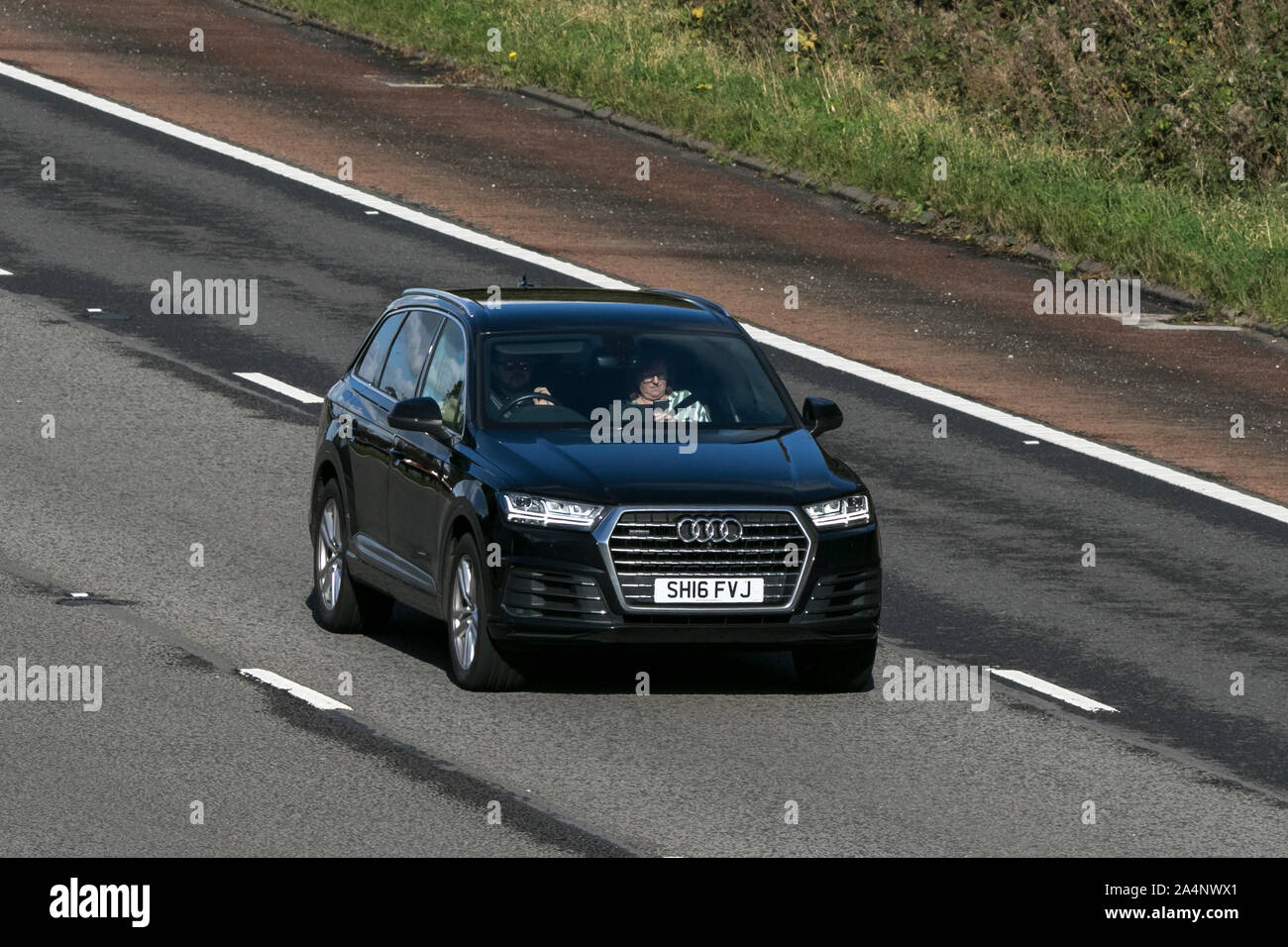 2016 BLACK Audi Q7 S Line TDI Quattro AUT; traveling on the M6 motorway near Preston in Lancashire, UK Stock Photo