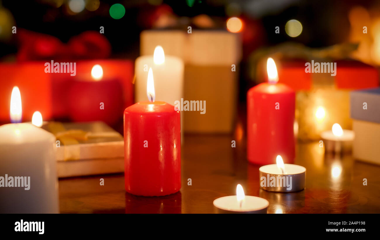 Beautiful background for Christmas with burning red and white candles