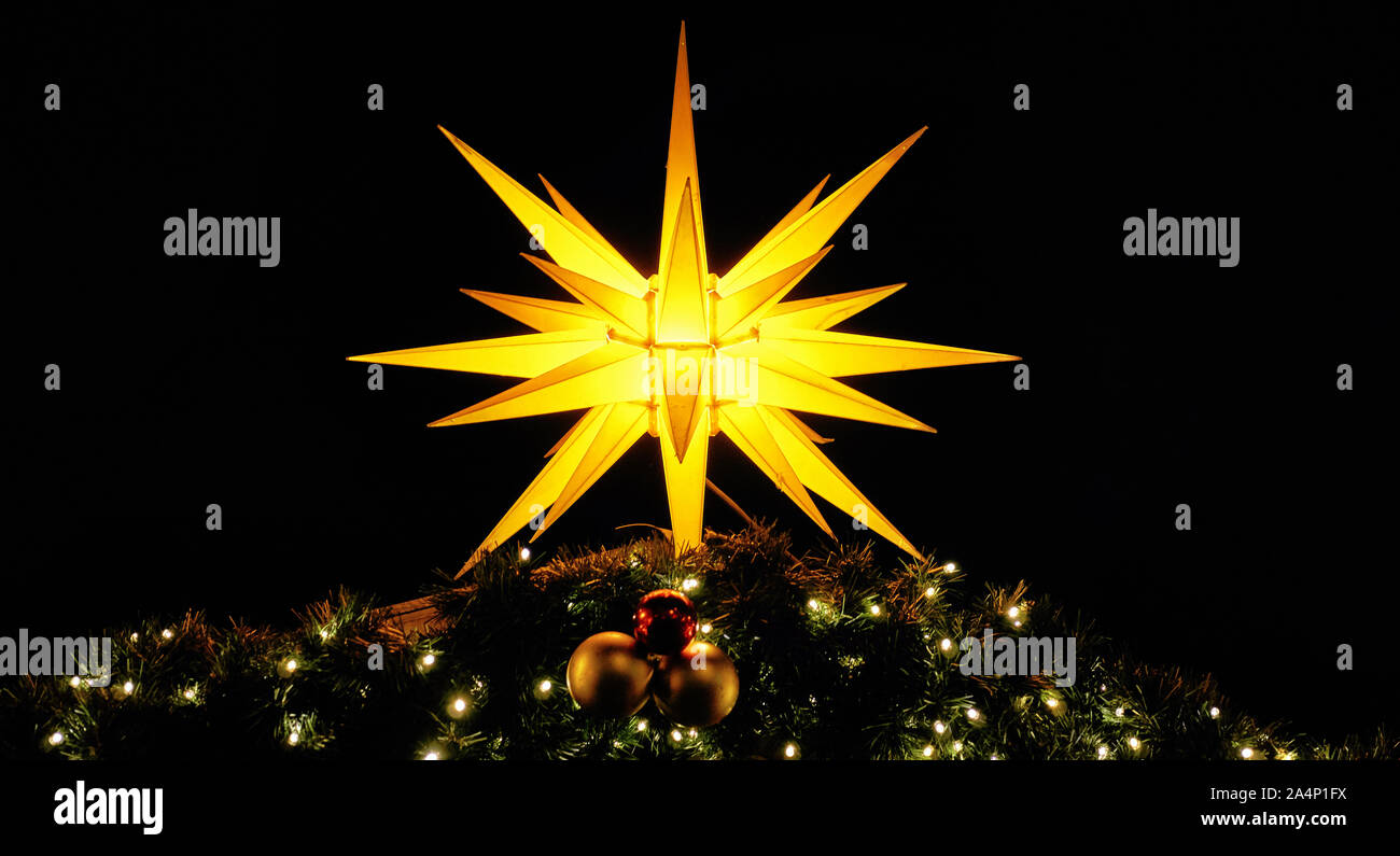 Panorama with shining Christmas star on fir branches. Christmas decoration in the night. Stock Photo