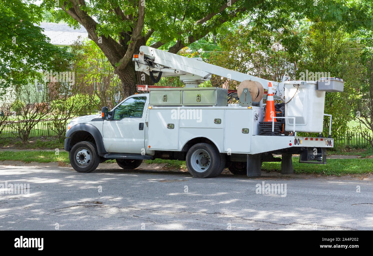 Communication utility trucks parked in residential neighbourhood. Horizontal. Stock Photo