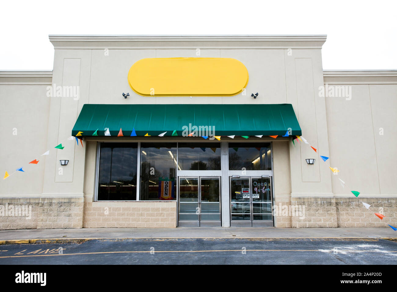 Storefront grand opening with blank yellow Sign and banner flags. Horizontal. Stock Photo