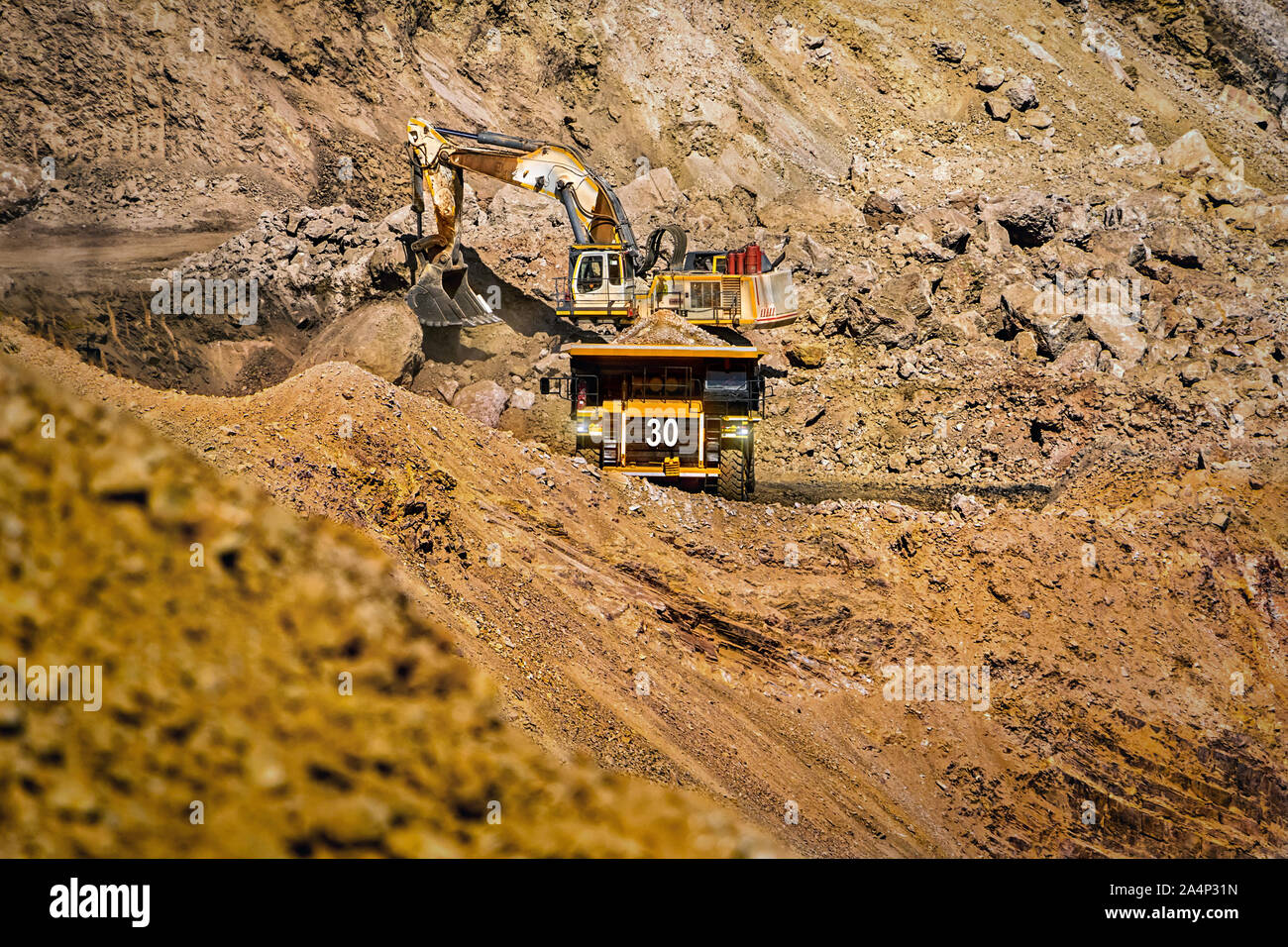 An open pit diamond mine in Botswana with heavy machinery on site. Stock Photo