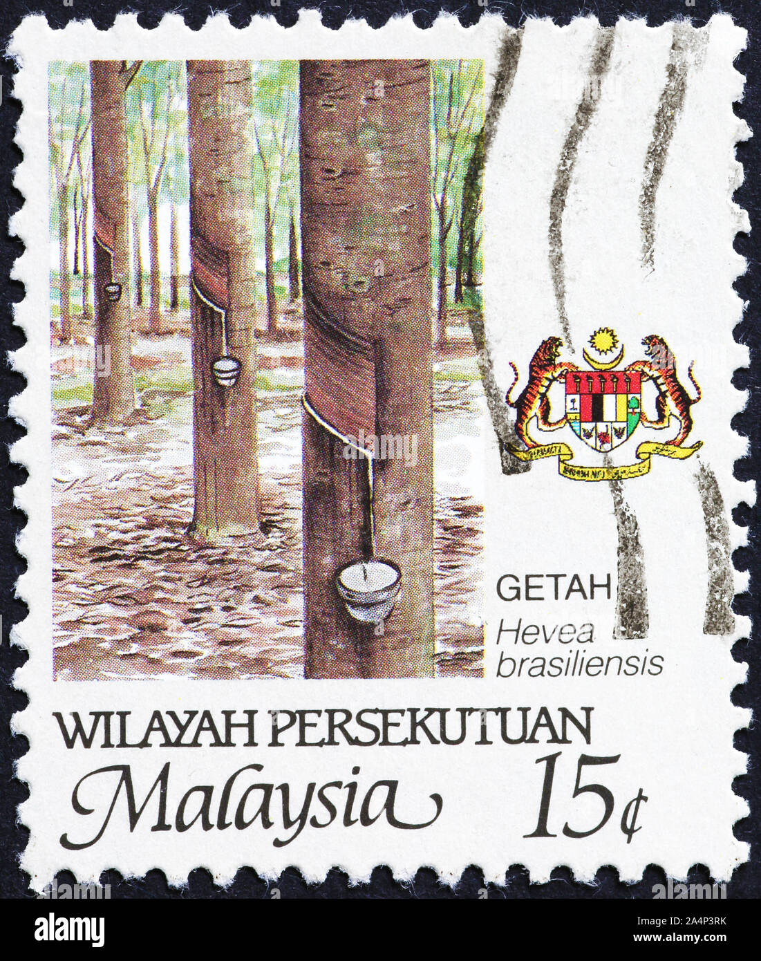 Latex collection from rubber trees on malaysian stamp Stock Photo
