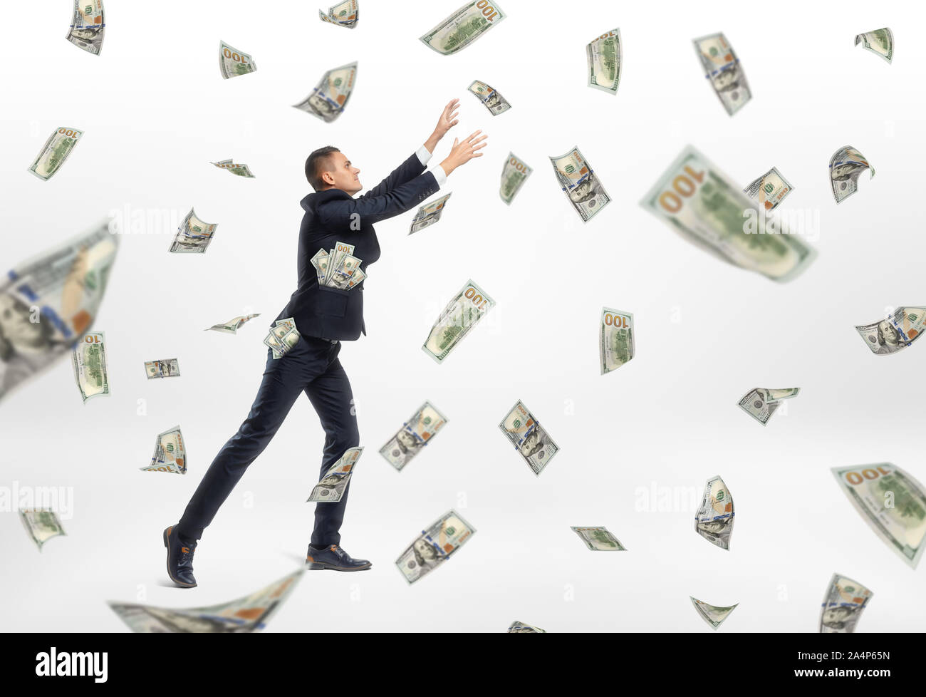 Lot of cash money flying and businessman catching them Stock Photo Alamy