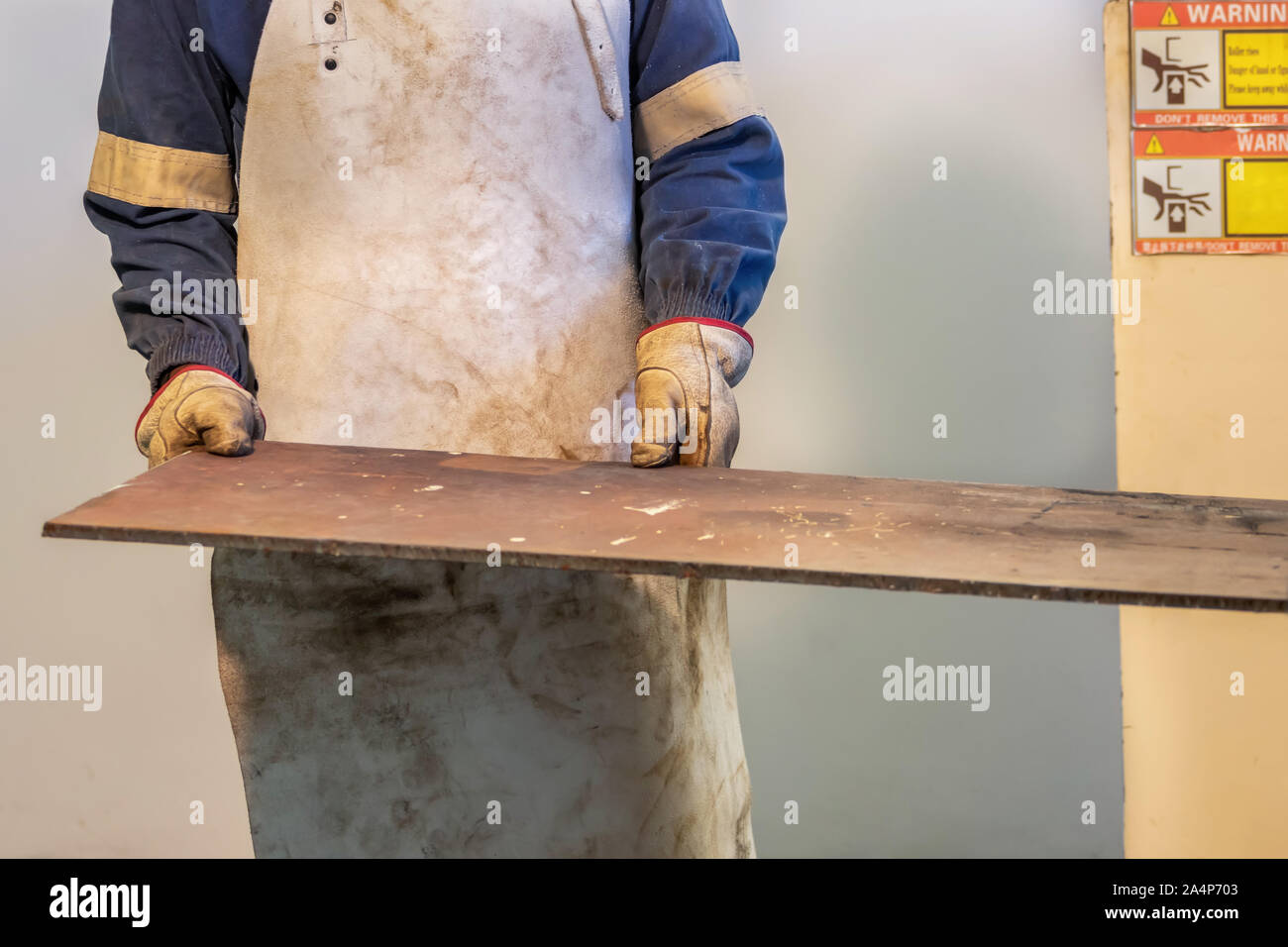 Motswana worker operating a Rolling Machine in a Botswana workshop Stock Photo