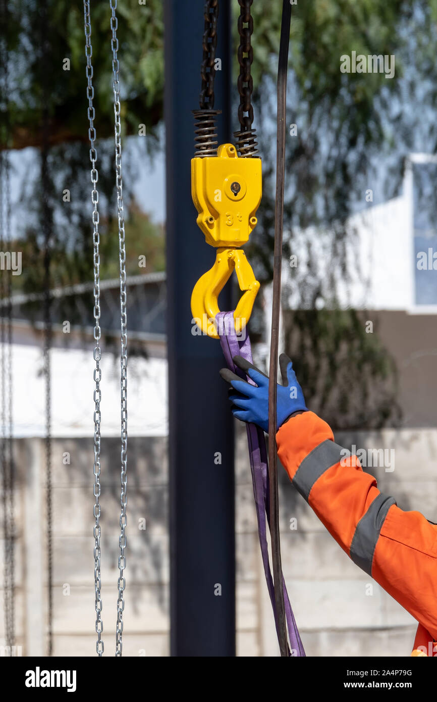 Yellow crane hook and a chain hoisting weight Stock Photo Alamy