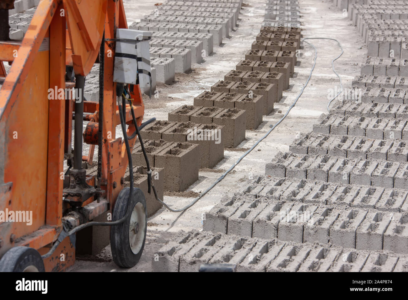 bricks and a brick machine on a construction site in Botswana, Africa Stock Photo