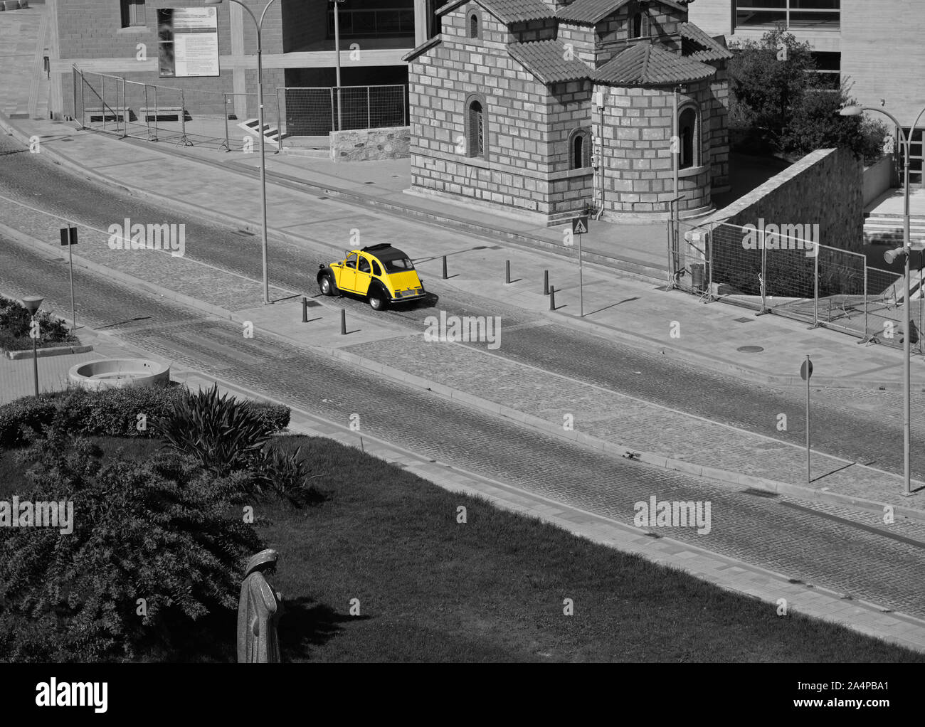 Yellow Citroen 2CV vintage car with a sunroof passing over a zebra crossing at Heraklion, Crete, Greece. Stock Photo