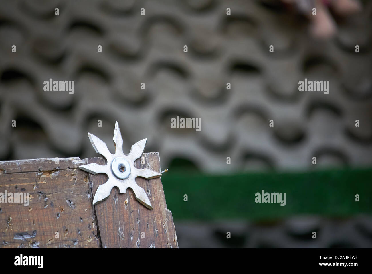 Close up throwing board for throwing star decorated with broken