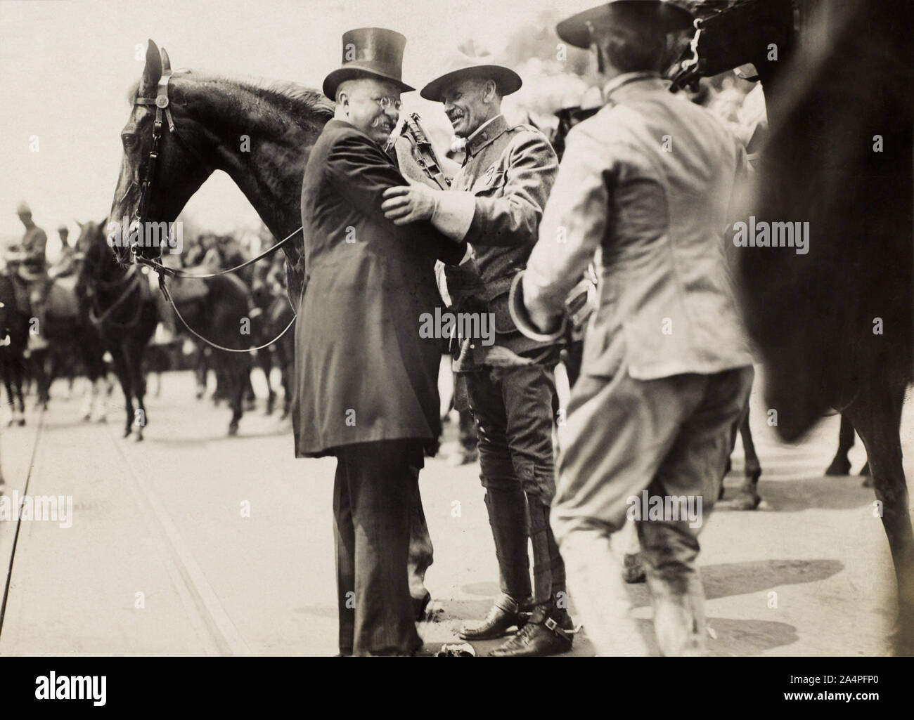 Theodore Roosevelt and Col. Alexander O. Brodie, in Uniform, Greeting each other, Surrounded by Horses, Photograph by Paul Thompson, June 1910 Stock Photo