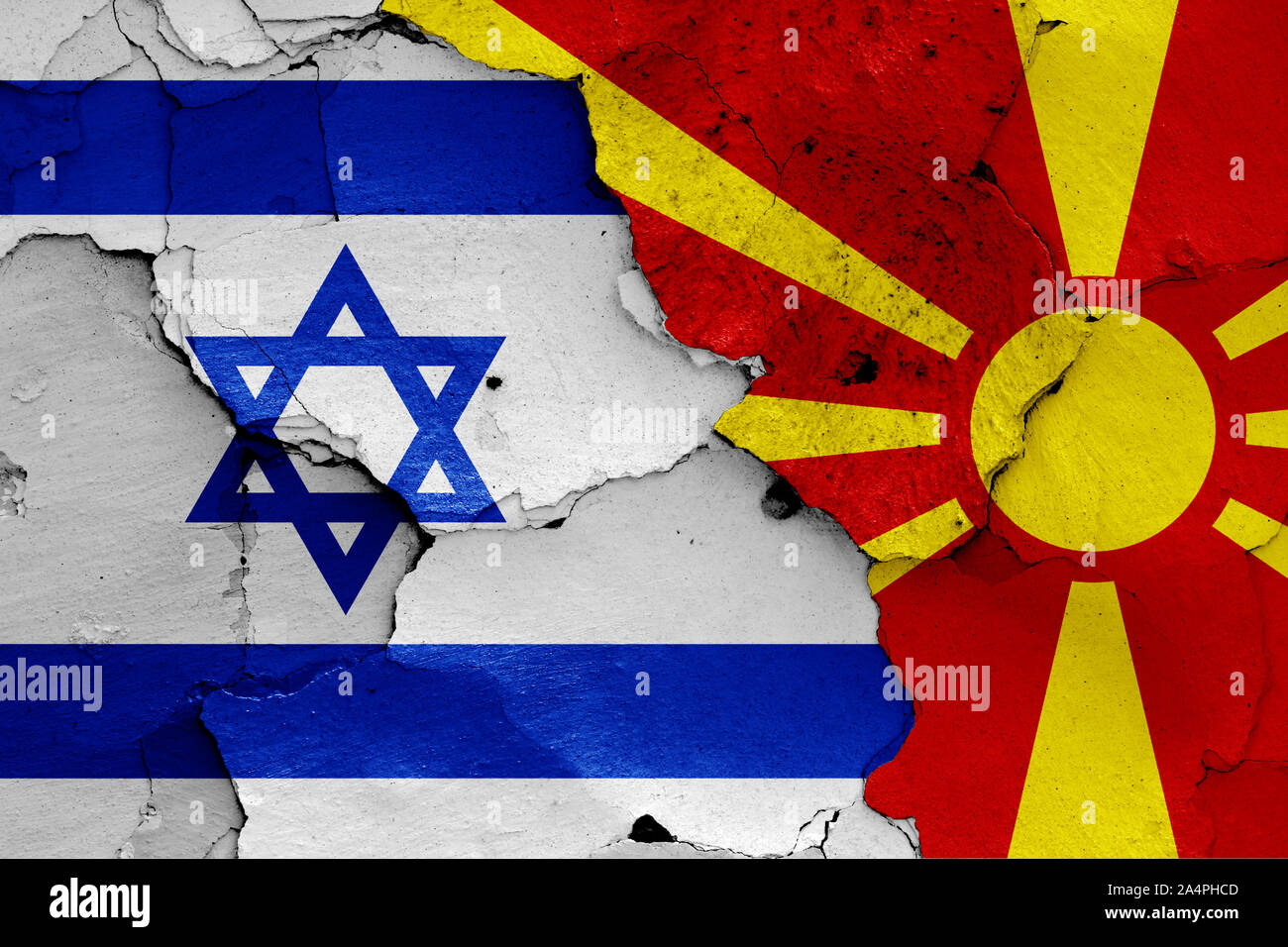 flags of Israel and North Macedonia painted on cracked wall Stock Photo