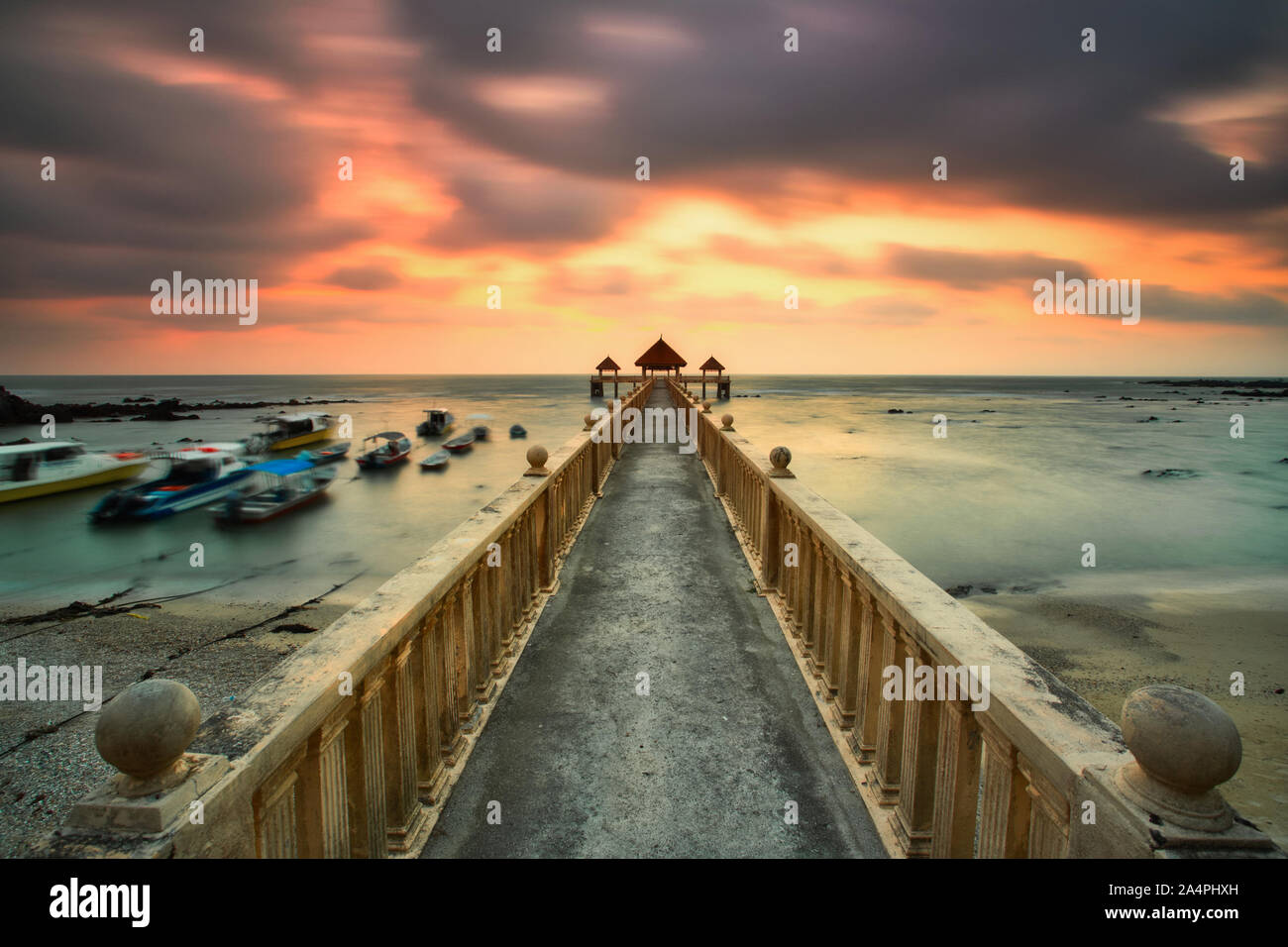 A long exposure of a stone jetty leading into the sea during monsun season, Tanjung Balau,Johore,Malaysia Stock Photo