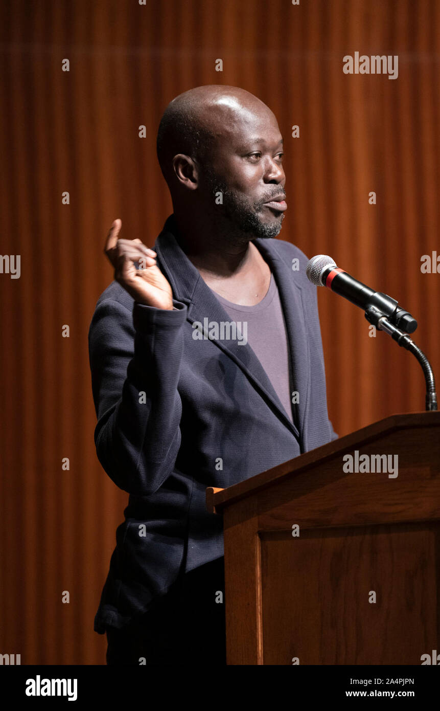 Noted British architect Sir David Adjaye, a native of Ghana, speaks about his international practice during a lecture at the University of Texas at Austin. Adjaye recently was awarded a commission to design the Abrahamic Family House project in Abu Dhabi. Stock Photo