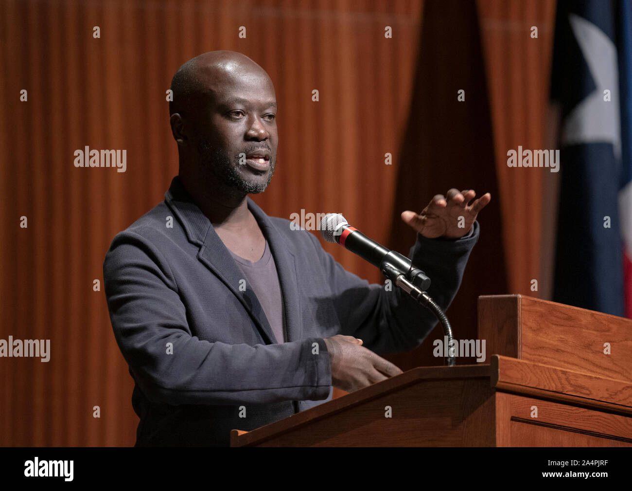 Noted British architect Sir David Adjaye, a native of Ghana, speaks about his international practice during a lecture at the University of Texas at Austin. Adjaye recently was awarded a commission to design the Abrahamic Family House project in Abu Dhabi. Stock Photo