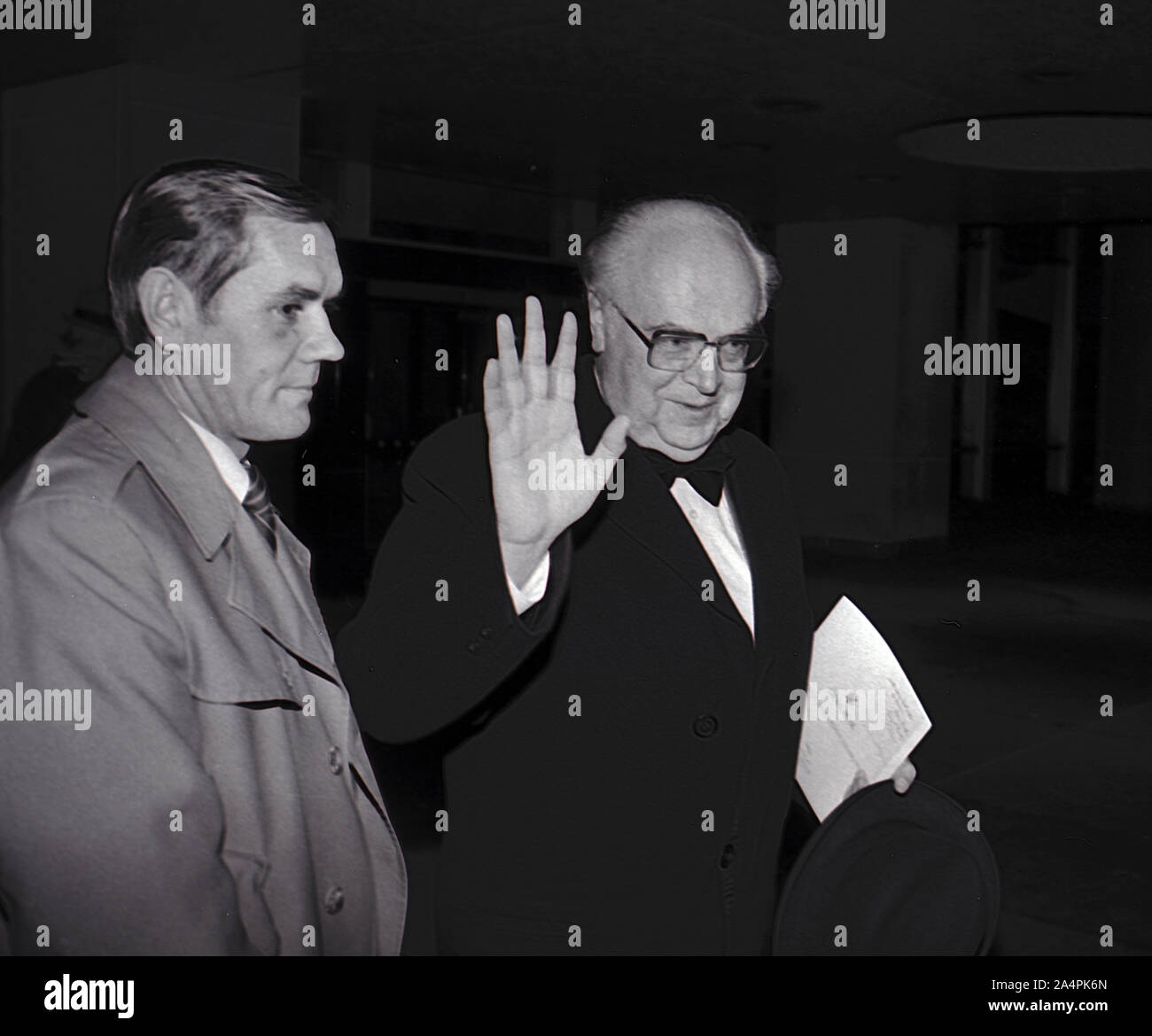 Washington DC, USA, December 3, 1983 Soviet Ambassador the United States Anatoly Dobrynin accompanied by his KGB security escort waves at the camera as he leaves the evening reception at the United States State Department for the Kennedy Center Honors Stock Photo