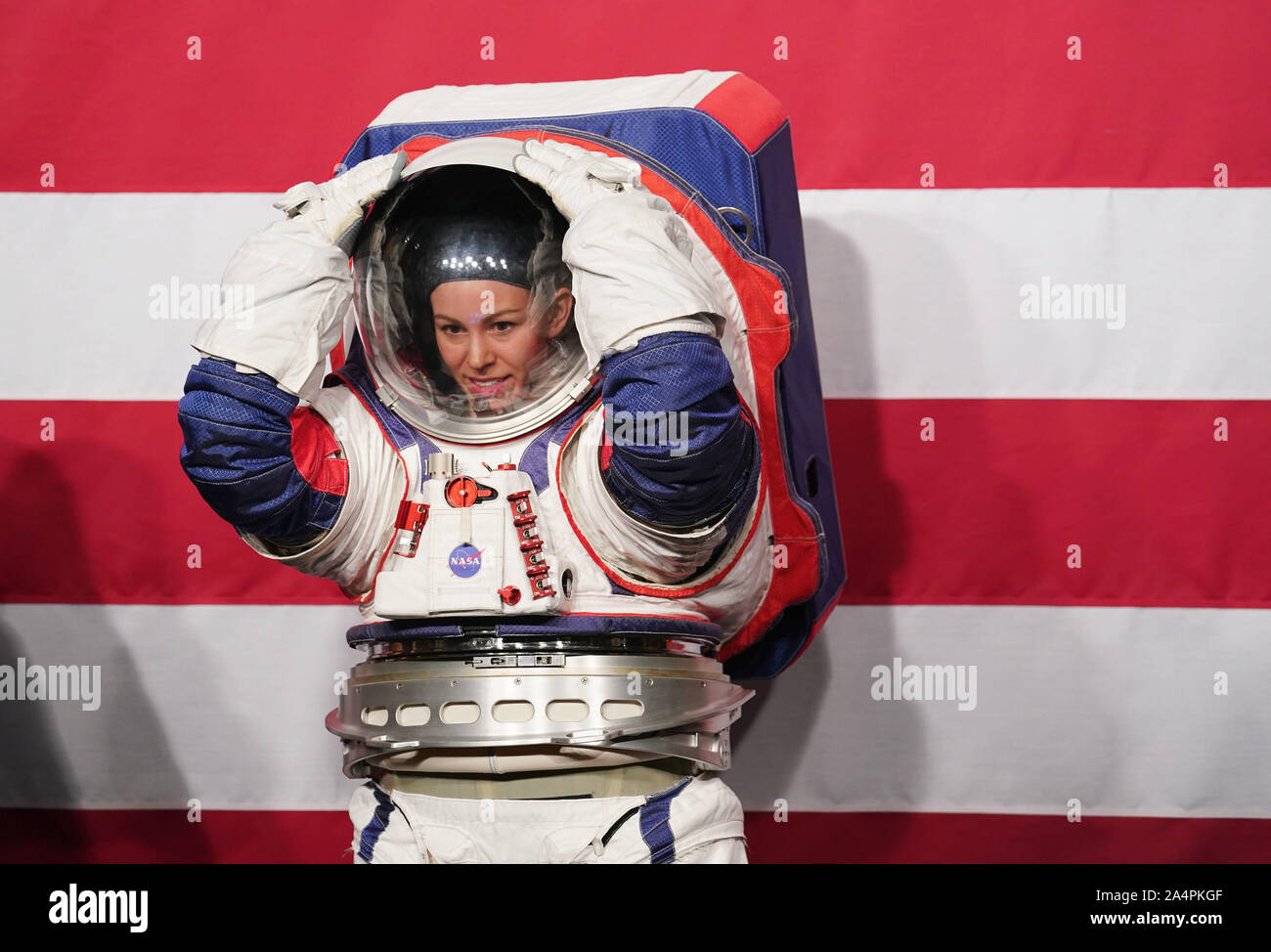 Washington, USA. 15th Oct, 2019. Advanced Space Suit Engineer Kristine Davis displays the Exploration Extravehicular Mobility Unit (xEMU) spacesuit at NASA headquarters in Washington, DC, the United States, on Oct. 15, 2019. The U.S. space agency NASA unveiled on Tuesday the next-generation spacesuits to be used in its Artemis program that will send the first woman and next man to the Lunar South Pole by 2024. Credit: Liu Jie/Xinhua/Alamy Live News Stock Photo
