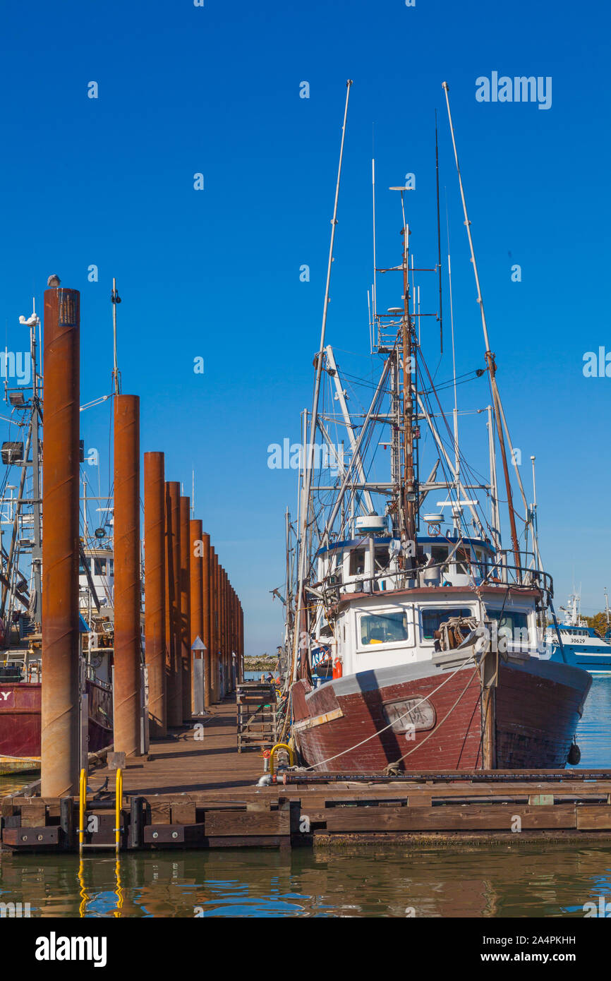 Wooden hulled fishing vessel with a name in Japanese characters docked in Steveston British Columbia Canada Stock Photo