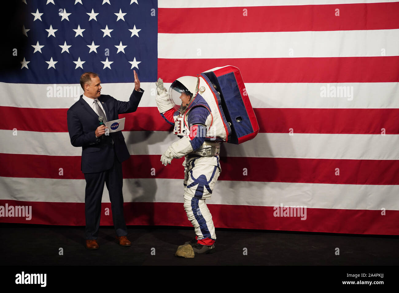 Washington, USA. 15th Oct, 2019. NASA Administrator Jim Bridenstine (L) welcomes Advanced Space Suit Engineer Kristine Davis, who wears the Exploration Extravehicular Mobility Unit (xEMU) spacesuit, at NASA headquarters in Washington, DC, the United States, on Oct. 15, 2019. The U.S. space agency NASA unveiled on Tuesday the next-generation spacesuits to be used in its Artemis program that will send the first woman and next man to the Lunar South Pole by 2024. Credit: Liu Jie/Xinhua/Alamy Live News Stock Photo