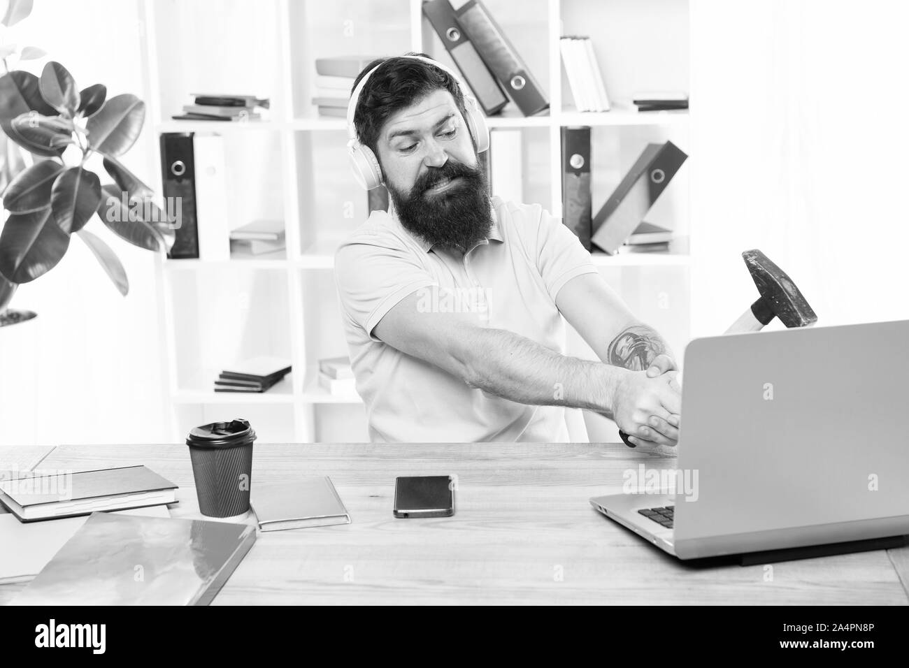 Computer lag. Reasons for computer lagging. How fix slow lagging system. Hate office routine. Man bearded guy headphones office swing hammer on computer. Slow internet connection. Outdated software. Stock Photo