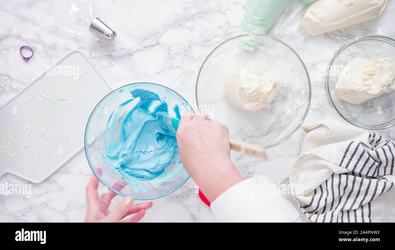 Mixing food coloring with buttercream frosting Stock Photo - Alamy