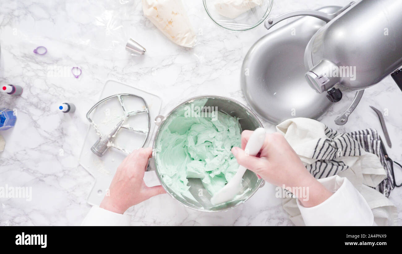 Mixing ingredients in standing kitchen mixer to make buttercream