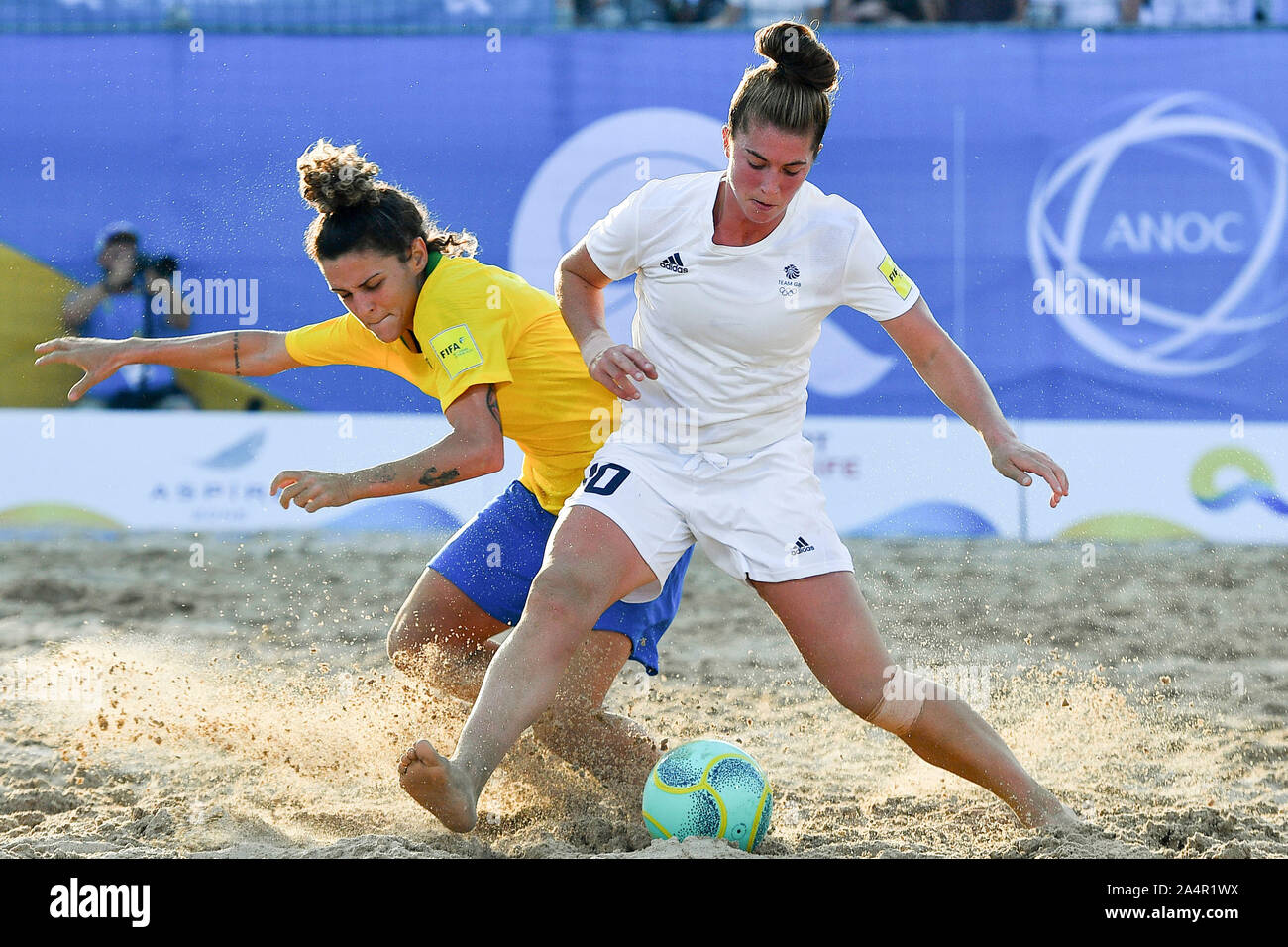 Doha, Qatar. 15th Oct, 2019. Leticia Villar Pais (L) of Brazil vies with Molly Lacey Clark (R) of Great Britain during the women's beach soccer semifinal at the 1st ANOC World Beach Games in Doha, capital of Qatar, Oct. 15, 2019. Credit: Nikku/Xinhua/Alamy Live News Stock Photo