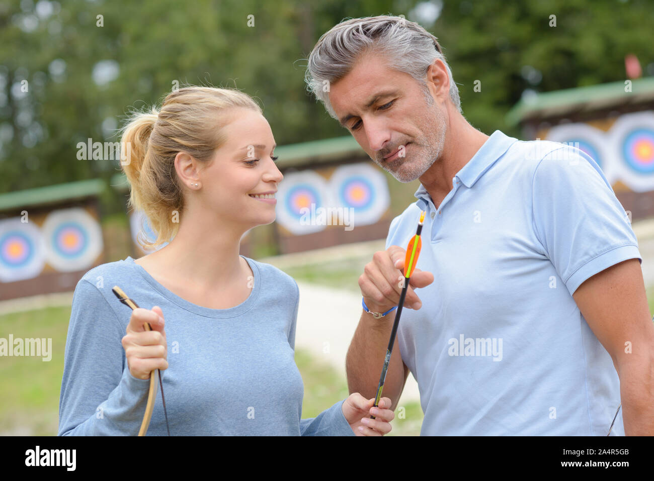 portrait of couple practicing archery Stock Photo