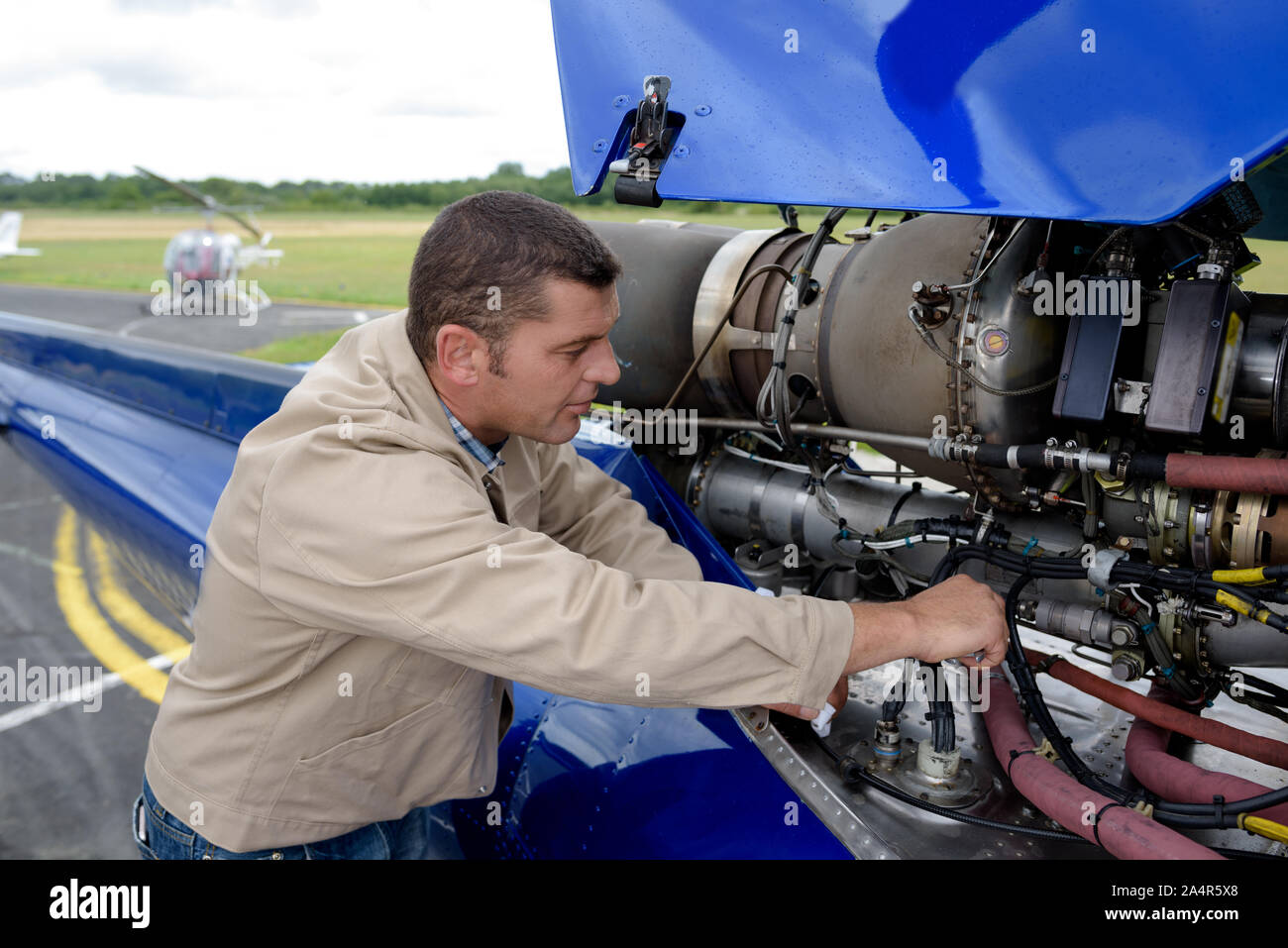 aviation mechanic working on an aircraft Stock Photo