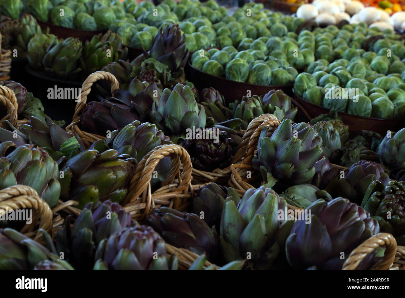 Biologic, natural cultivated artichoke, on a market counter. Vegetables from the farmers market. Ecologic products. Natural background. Stock Photo