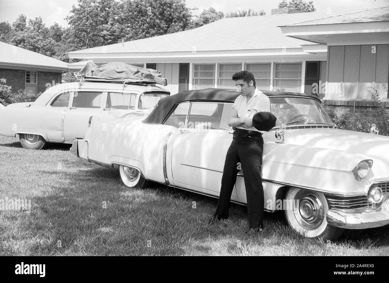 Elvis Presley with his Cadillacs in the yard at 1034 Audubon Drive