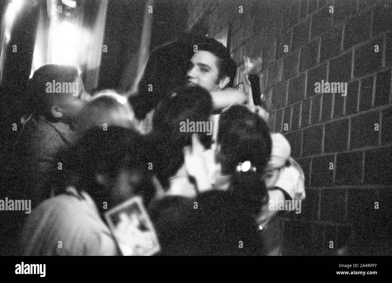 Elvis Presley being swarmed by fans at the University of Dayton Fieldhouse, May 27, 1956. Stock Photo