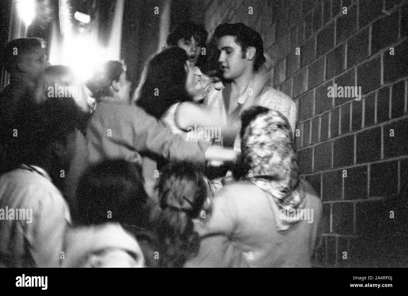 Elvis Presley being swarmed by fans at the University of Dayton Fieldhouse, May 27, 1956. Stock Photo