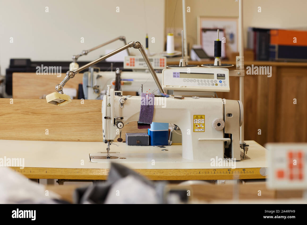 Image of sewing with sewing machines on the tables ready for