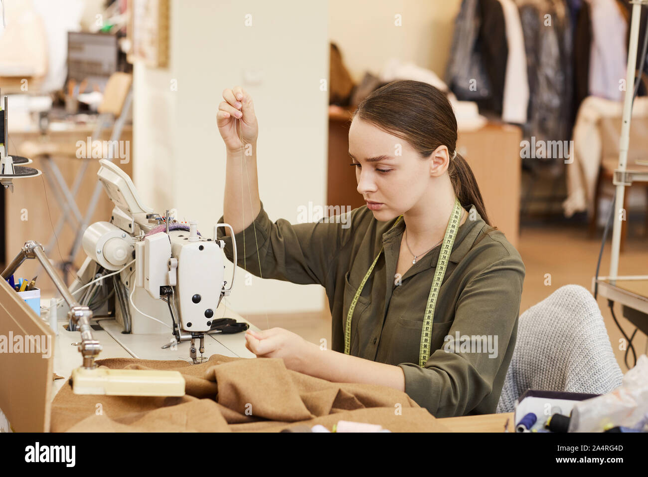 Professional tailor using sewing machine hi-res stock photography and ...