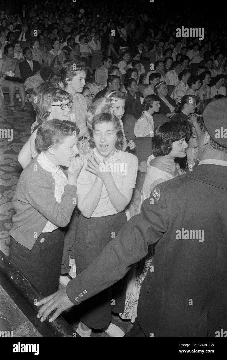 Elvis Presley fans reacting to his performance at the Fox Theater, Detroit, Michigan, May 25, 1956. Stock Photo