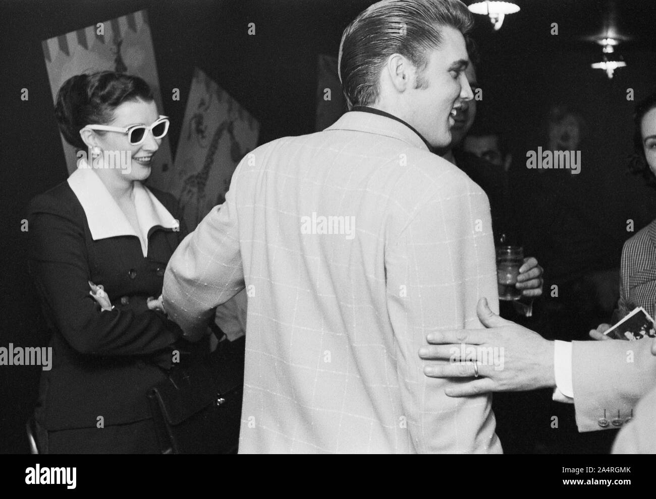 Elvis Presley speaking with fans at an adult party after his show at the Fox Theater, Detroit, Michigan, May 25, 1956. Stock Photo