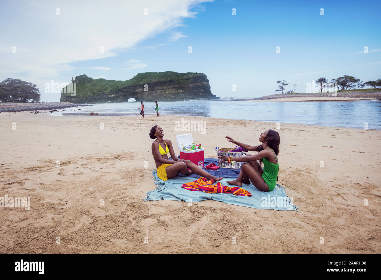 Two young women having a picnic at Hole in the Wall, Coffee Bay Stock Photo