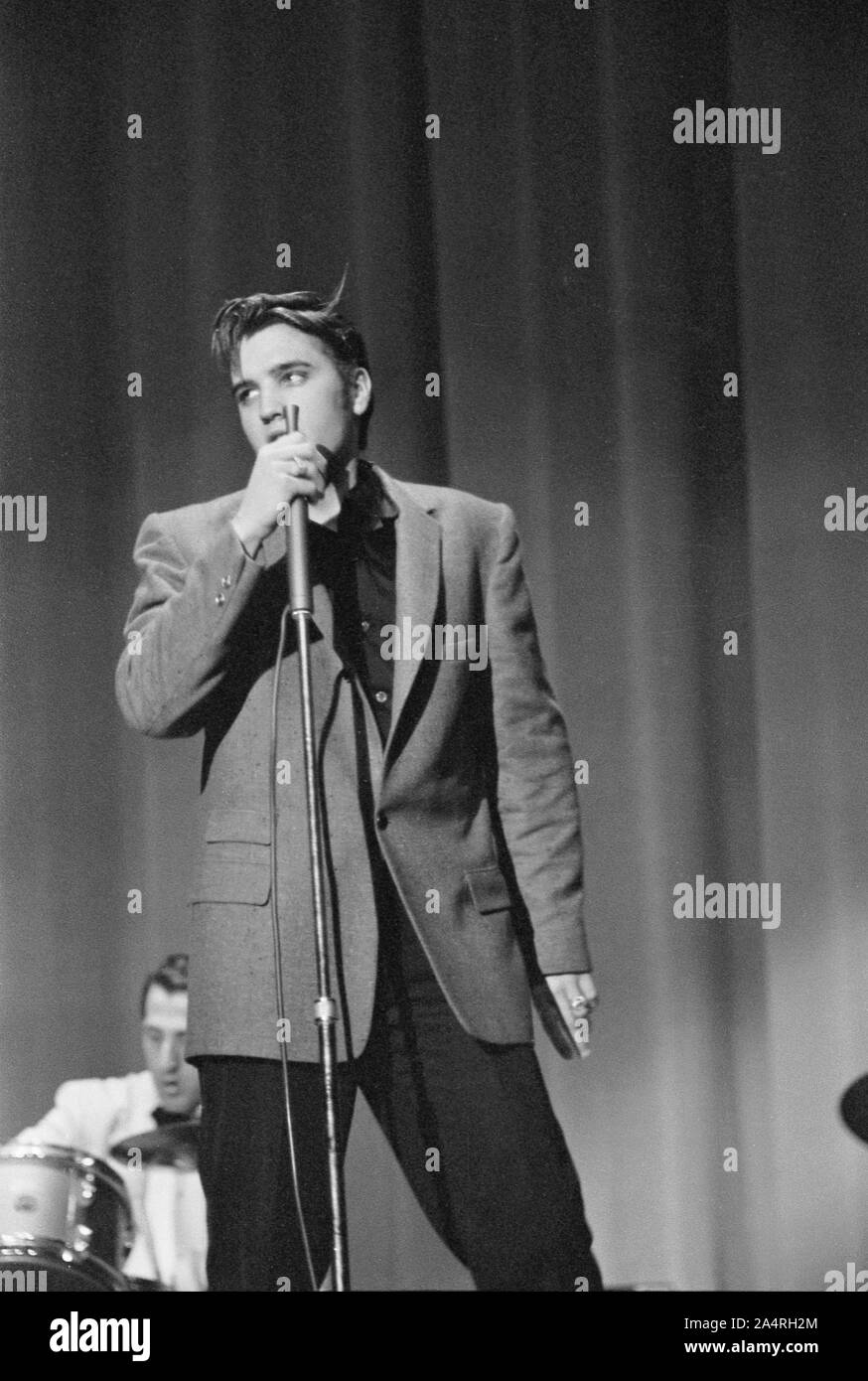 Elvis Presley performing on May 26, 1956. The performance took place at the Veteran’s Memorial Auditorium, Columbus, Ohio. Stock Photo