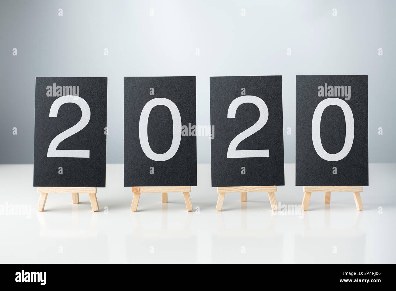 happy new year 2020 with blackboard on white table and grey background.holiday celebration Stock Photo