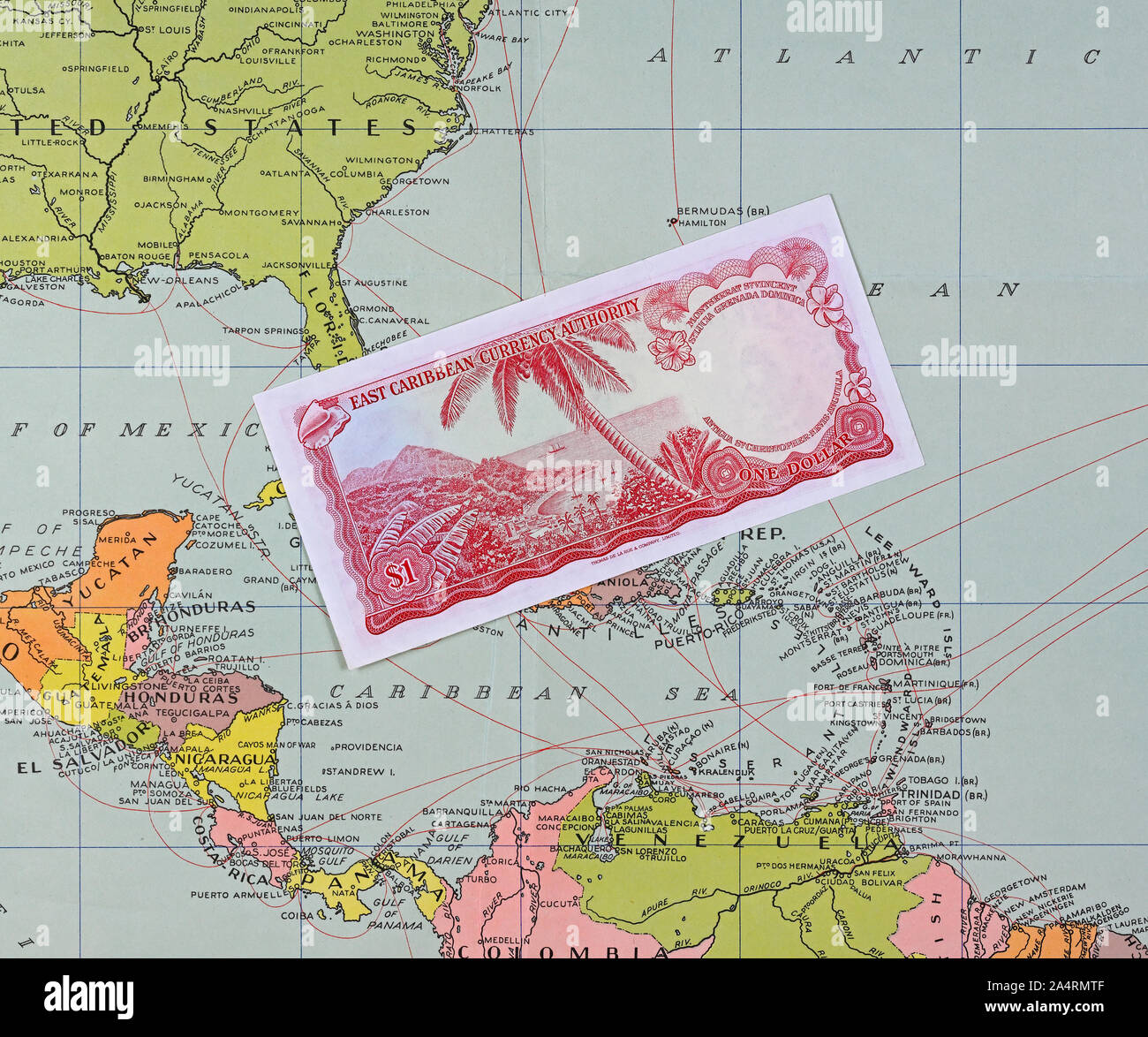 papenburg, germany - 2019.10.14: one dollar banknote of the east caribbean currency authority on a historic map of dutch knsm shipping company Stock Photo