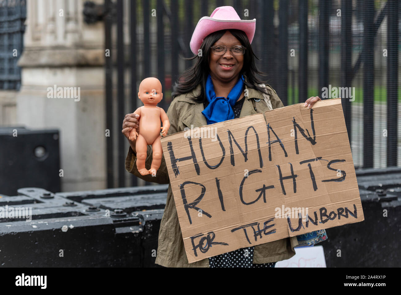 Black female holding a placard stating Human rights for the unborn. Fetal rights. Abortion protest Stock Photo