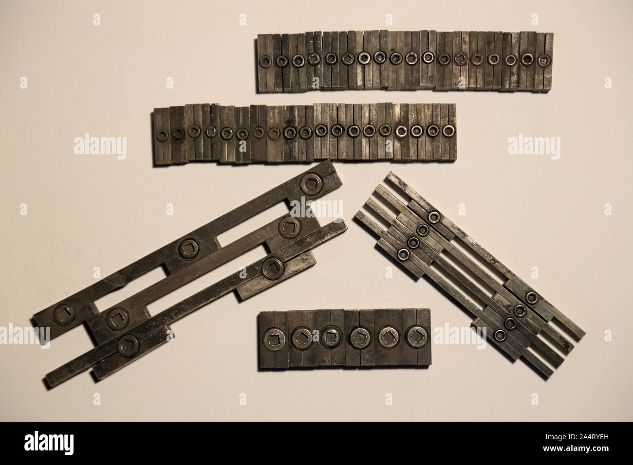 Quoins, a device for holding cutting dies, and letterpress type in