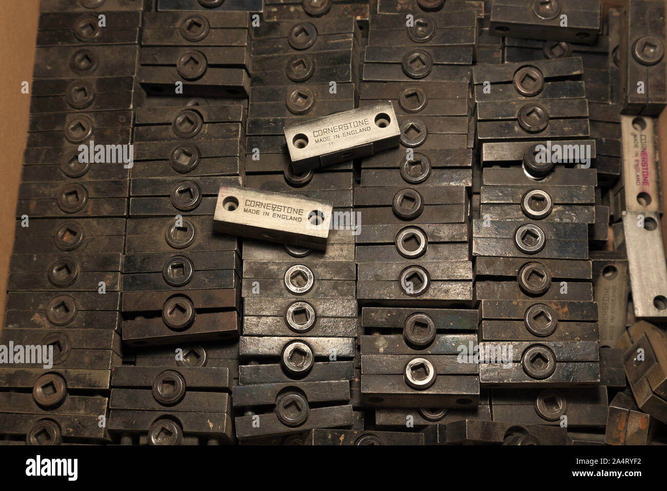 Quoins, a device for holding cutting dies, and letterpress type in
