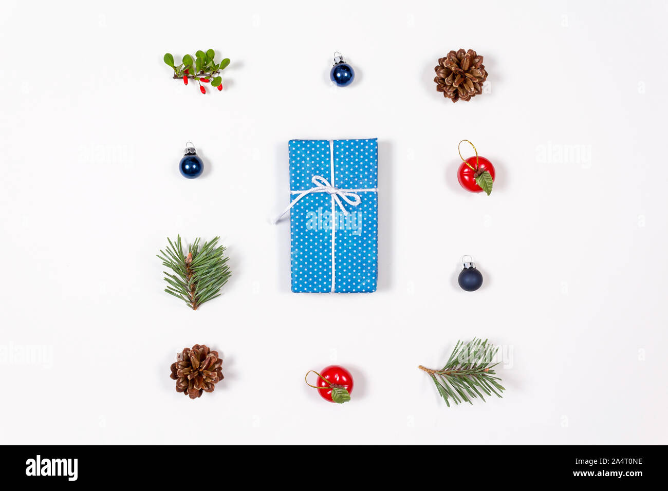 Creative flat lay of wrapped with bow gift in blue craft paper on white background. Flat lay, top view. Holidays collection and christmas concept. Stock Photo
